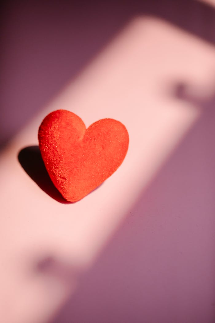 A vivid red heart casting a shadow, representing love and romance, perfect for Valentine's concepts.