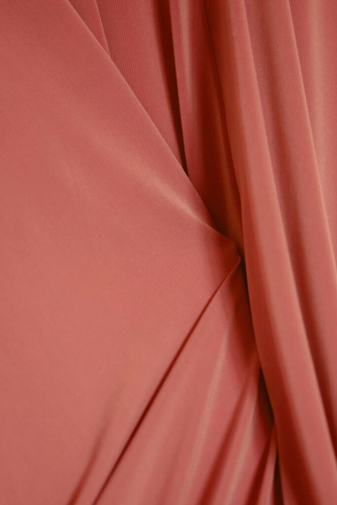 Red drape A close-up view of a soft pink velvet fabric, showing texture and folds.