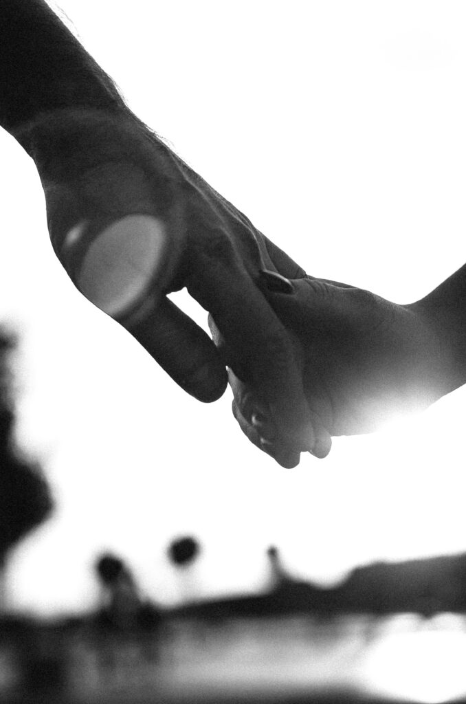Two hands holding Black and white image of two hands holding, capturing intimacy and connection. Perfect for themes of love and companionship.